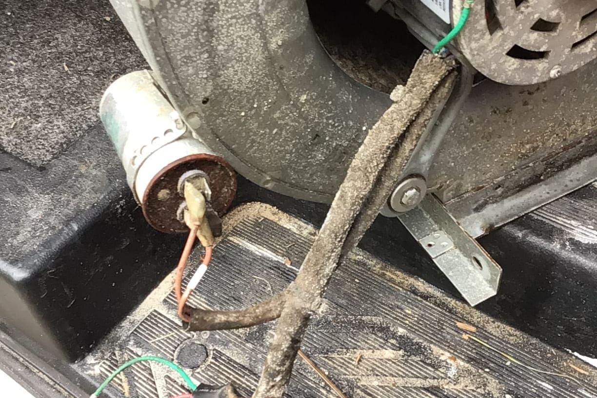 A run capacitor and frayed wiring found during a repair.