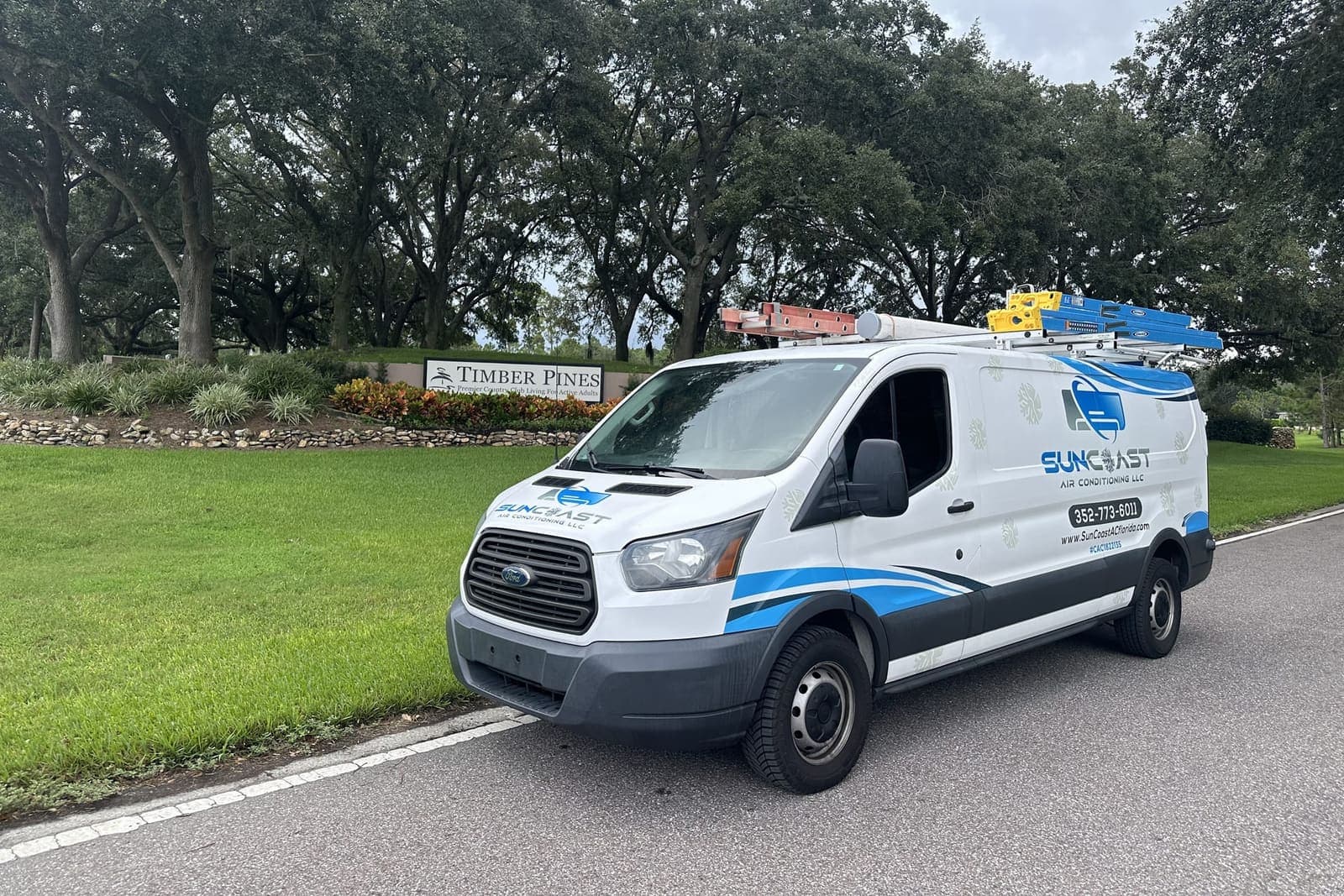 The SunCoast van parked beside a Timber Pines entrance sign in Timber Pines, Spring Hill, FL.