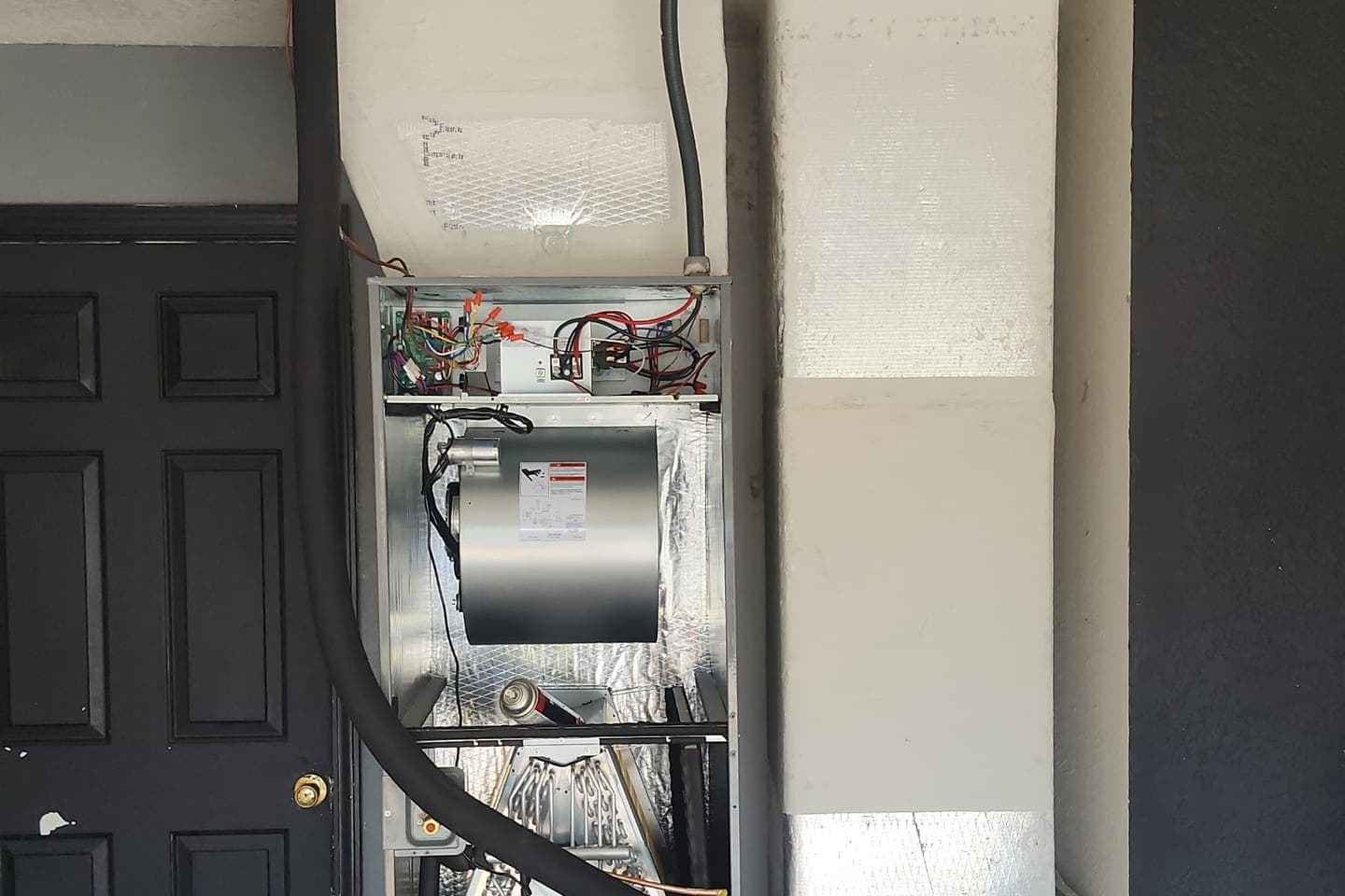 An air handler cabinet with its access panel open.