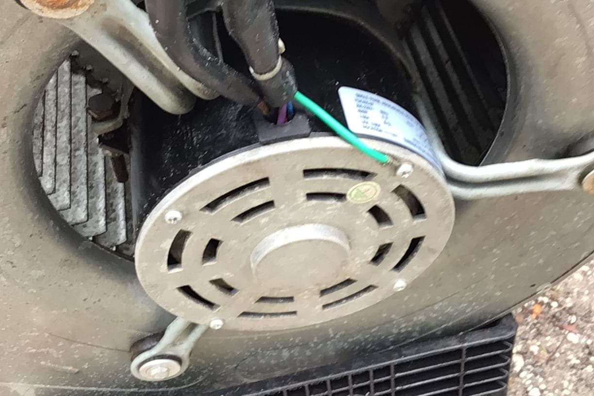A blower motor mounted on its housing.
