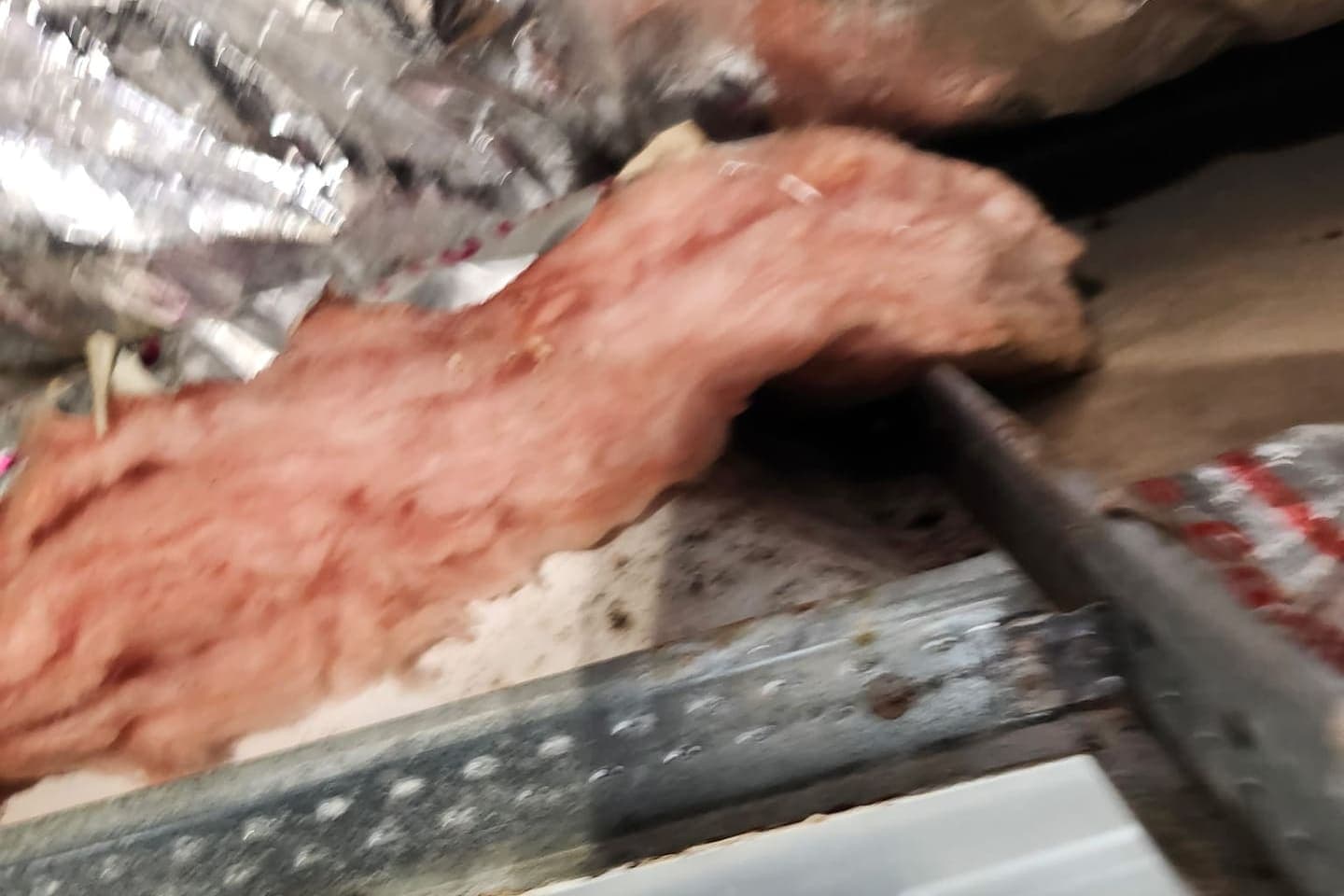Insulation torn out of a metal duct plenum.
