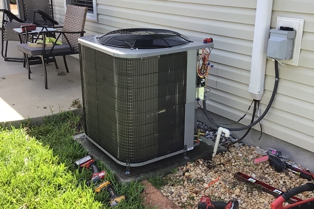 An outdoor condenser beside a patio on a Florida home.