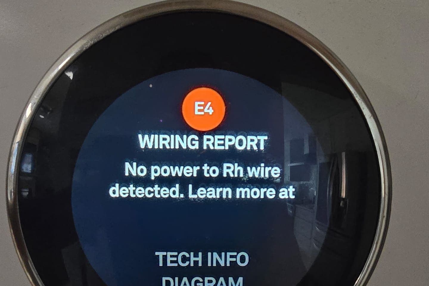 A smart thermostat displaying a wiring error.