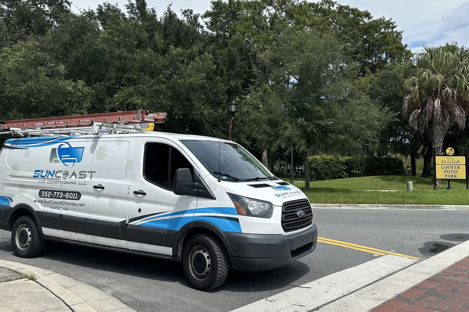 The SunCoast van parked by a brick plaza in Inverness, FL.