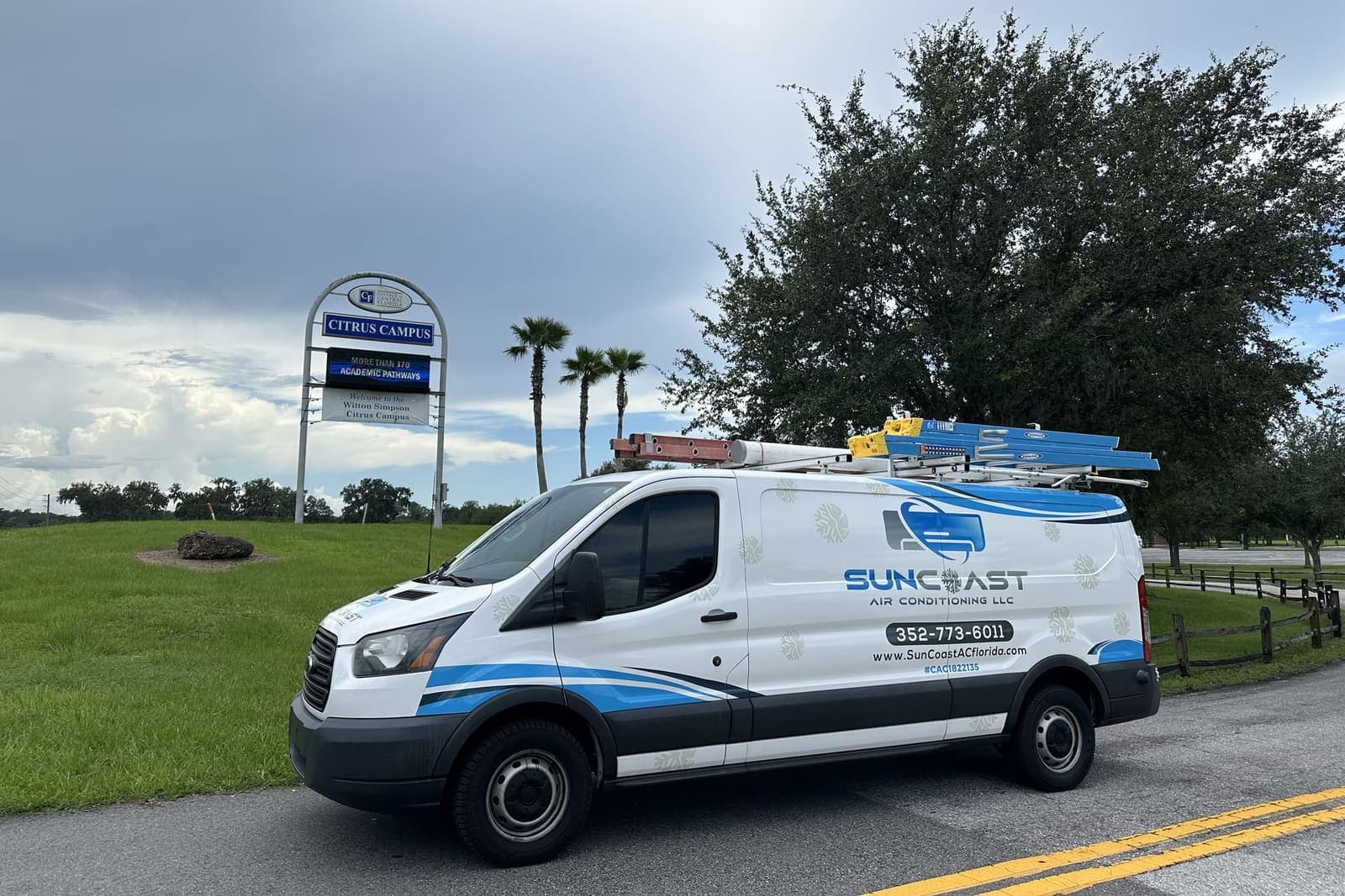 The SunCoast van parked beside a community park sign in Sugarmill Woods, FL.