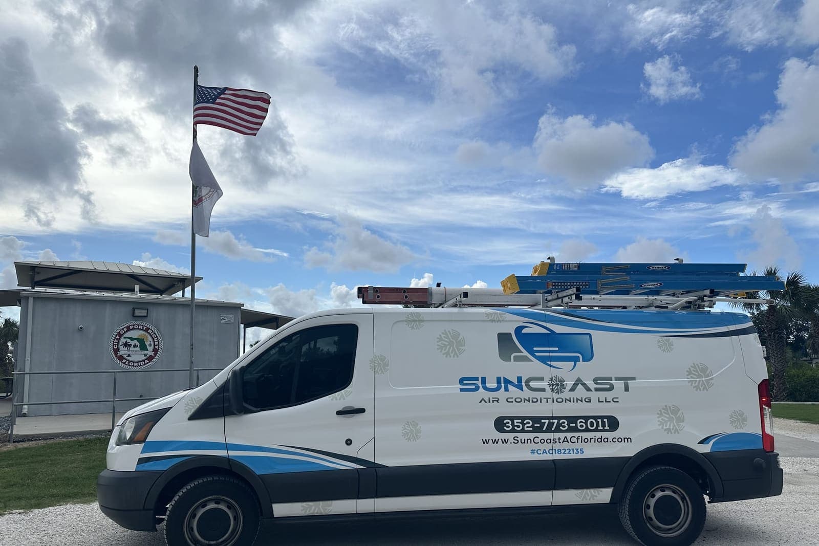 The SunCoast van parked beside a flag pole in Port Richey, FL.