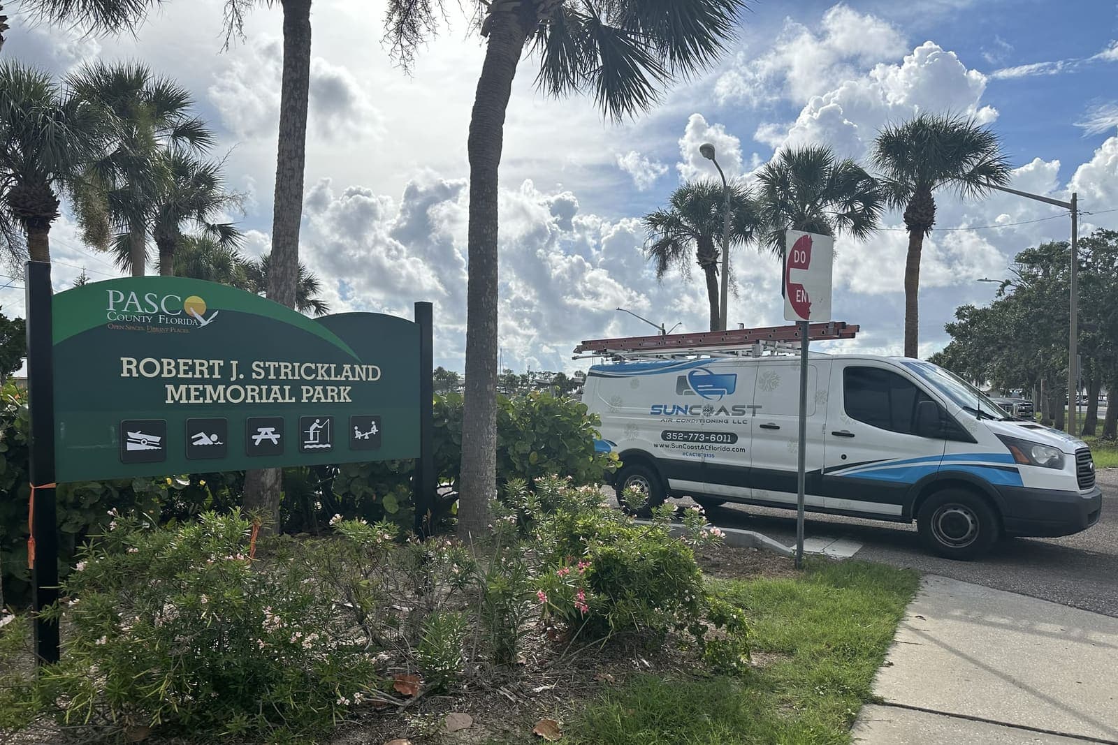 The SunCoast van parked beside the Robert J. Strickland Memorial Park sign in Hudson, FL.