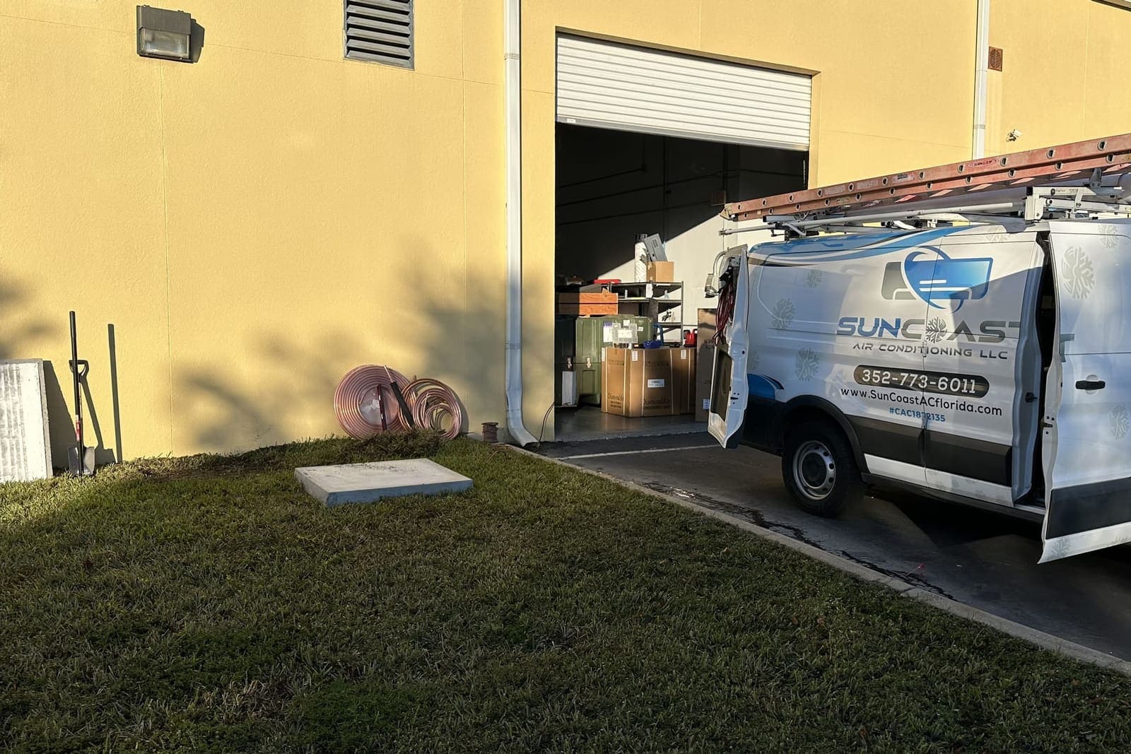 The SunCoast van parked beside a yellow stucco building in Hernando County, FL.