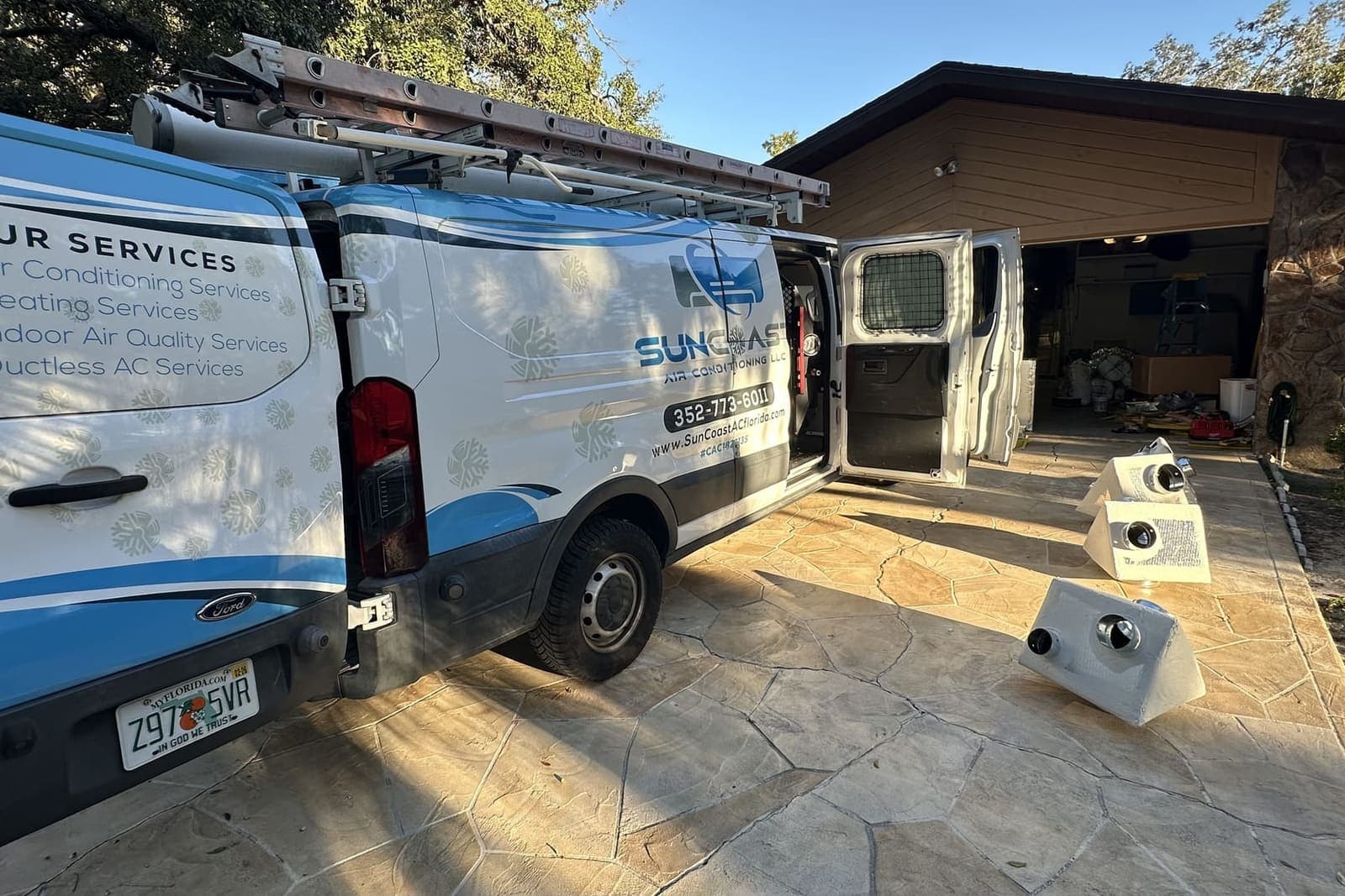 The SunCoast van with its side door open outside a garage in Hernando County, FL.