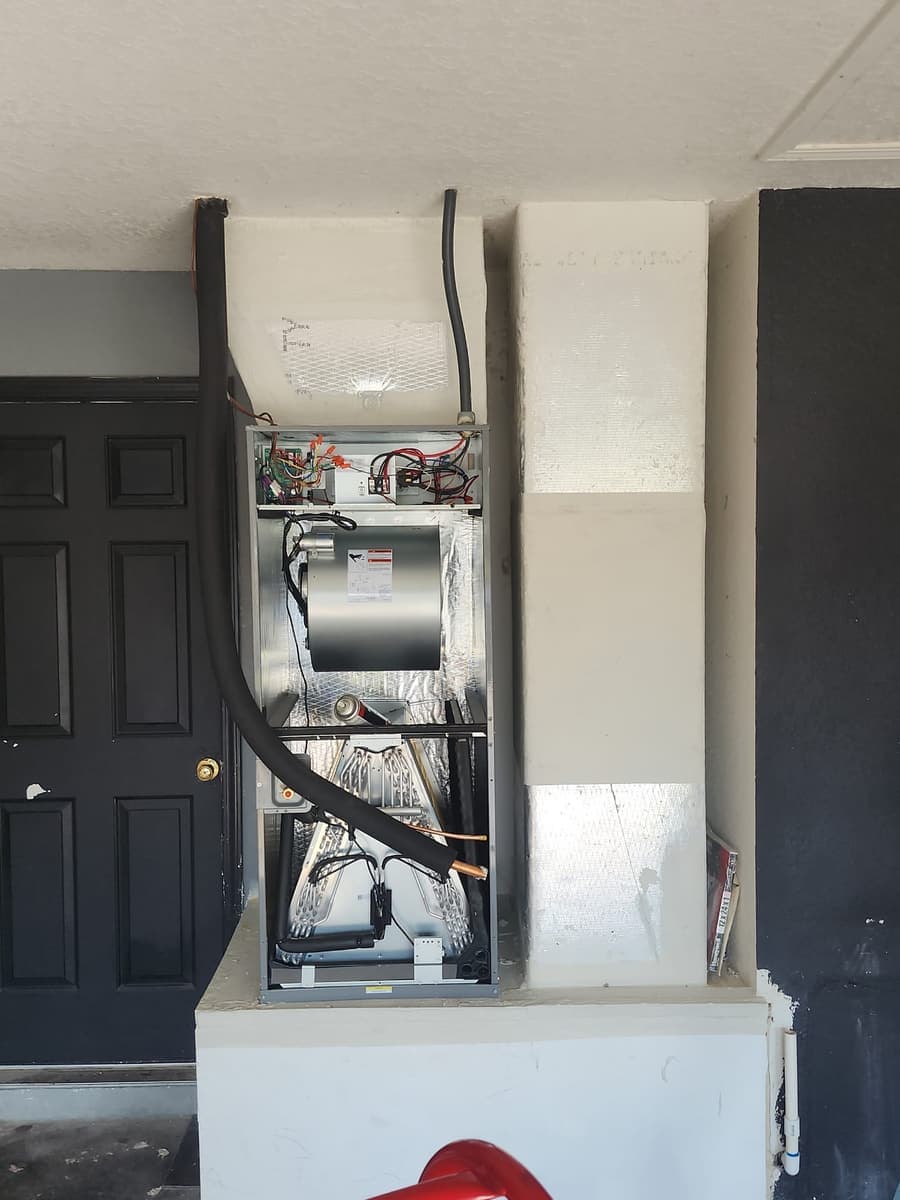 An air handler cabinet with its access panel open.