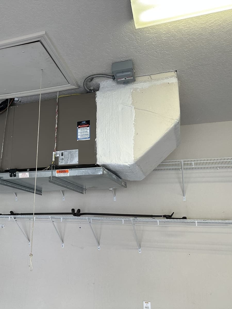 An air handler hung from the ceiling in a garage in Hernando County, FL.