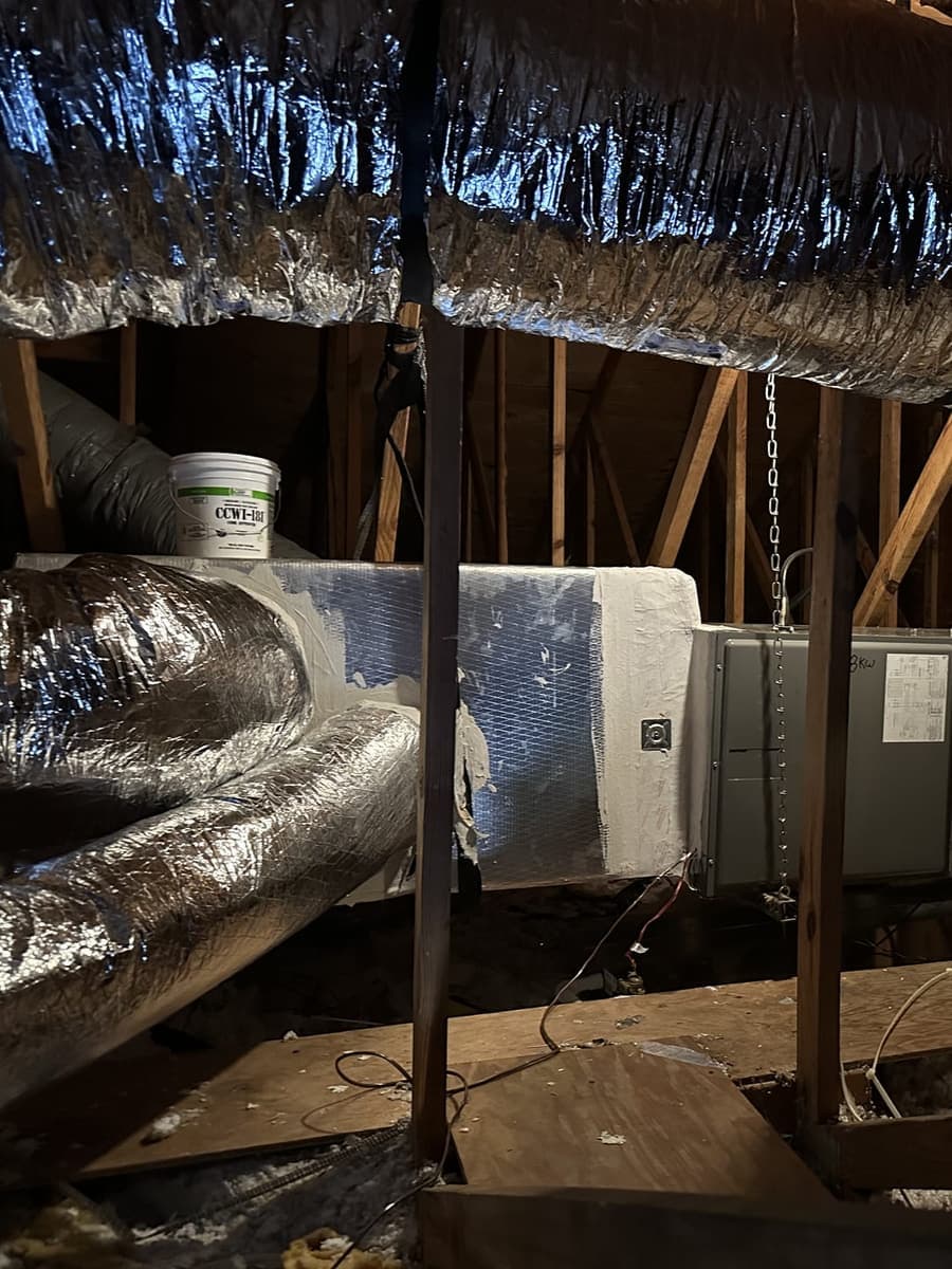 Attic ductwork and an air handler in the rafters in Spring Hill, FL.
