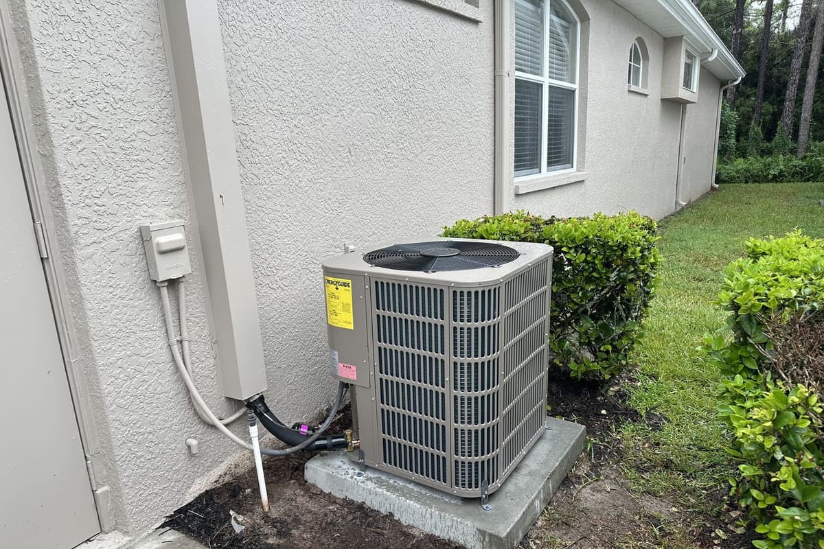 An outdoor condenser on a concrete pad beside a house in Hernando County, FL.