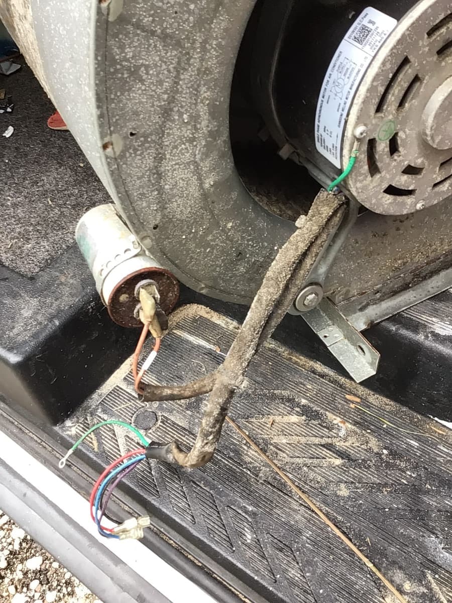 A run capacitor and frayed wiring found during a repair.