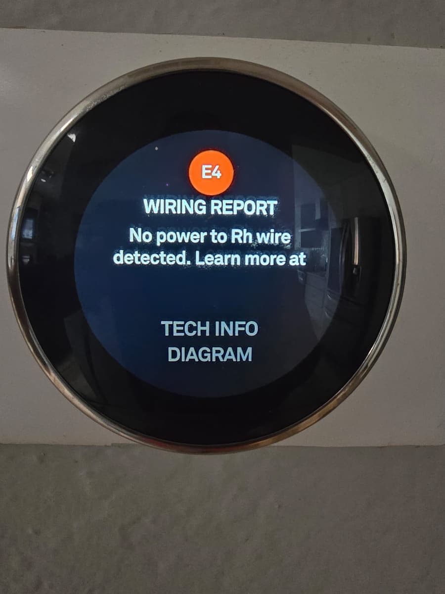 A smart thermostat displaying a wiring error.