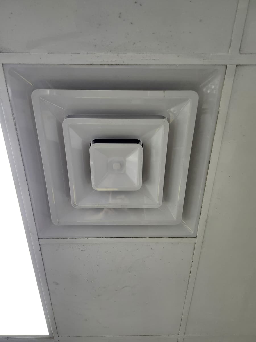 A square ceiling diffuser with a dirty perimeter.