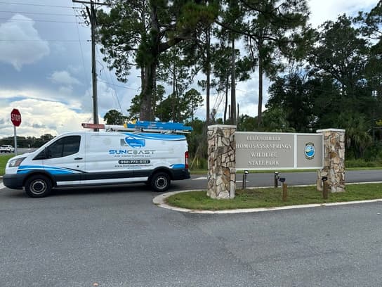 SunCoast Air Conditioning van at the entrance sign of Ellie Schiller Homosassa Springs Wildlife State Park