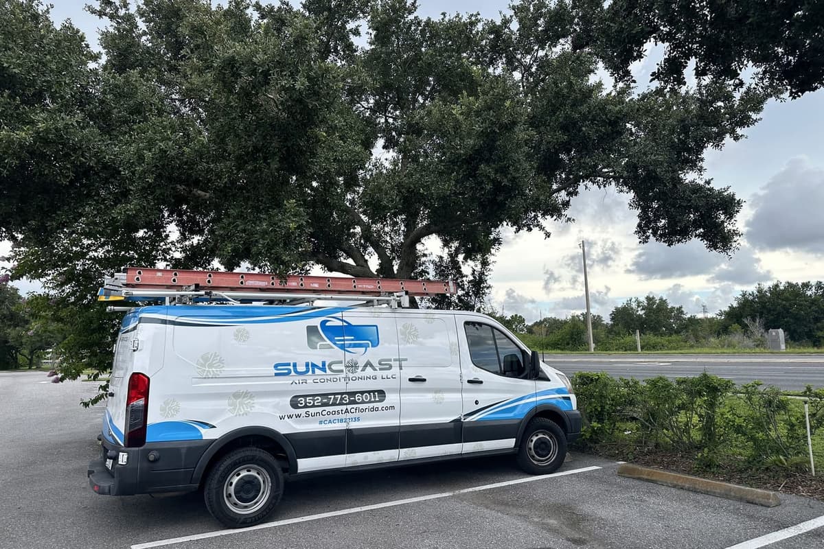 The SunCoast van parked beneath large live oaks in Trinity, FL.