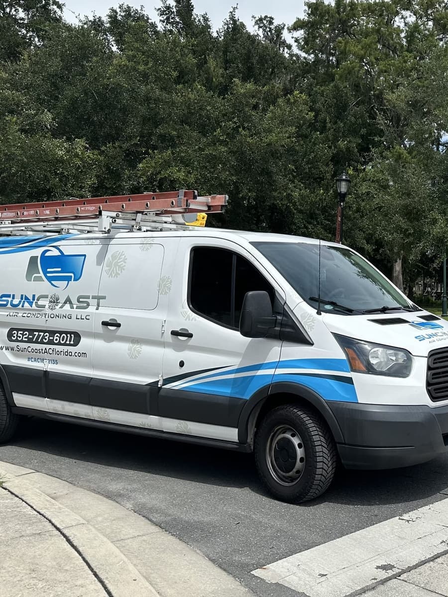 The SunCoast van parked by a brick plaza in Inverness, FL.
