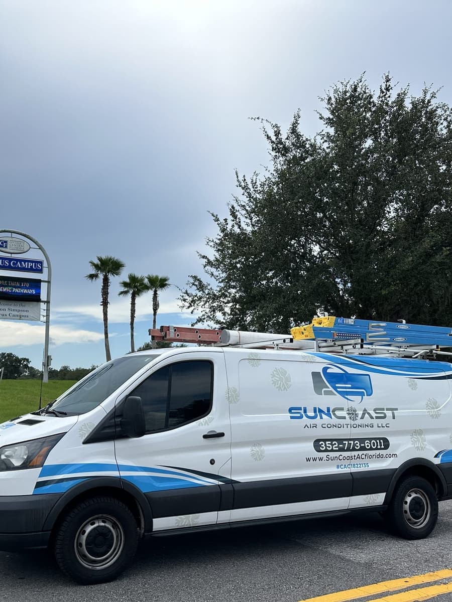 The SunCoast van parked beside a community park sign in Sugarmill Woods, FL.