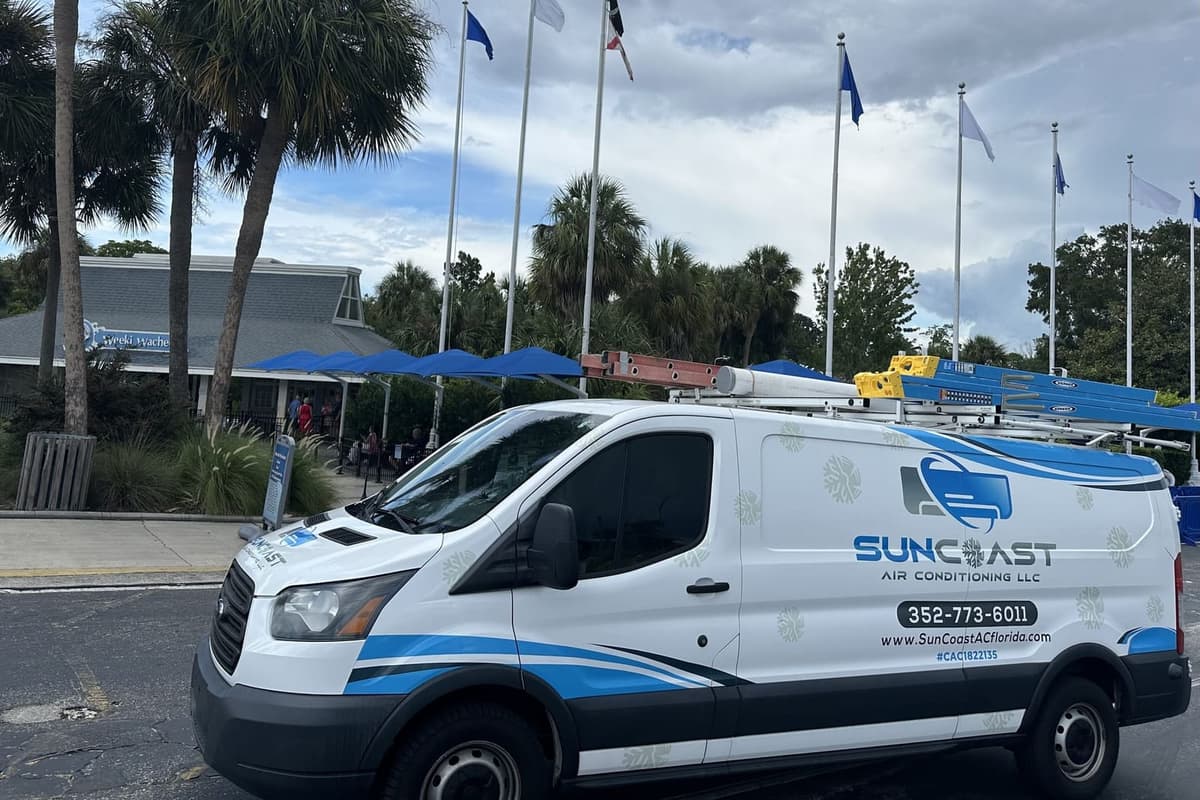 The SunCoast van parked under a row of flags in Weeki Wachee, FL.