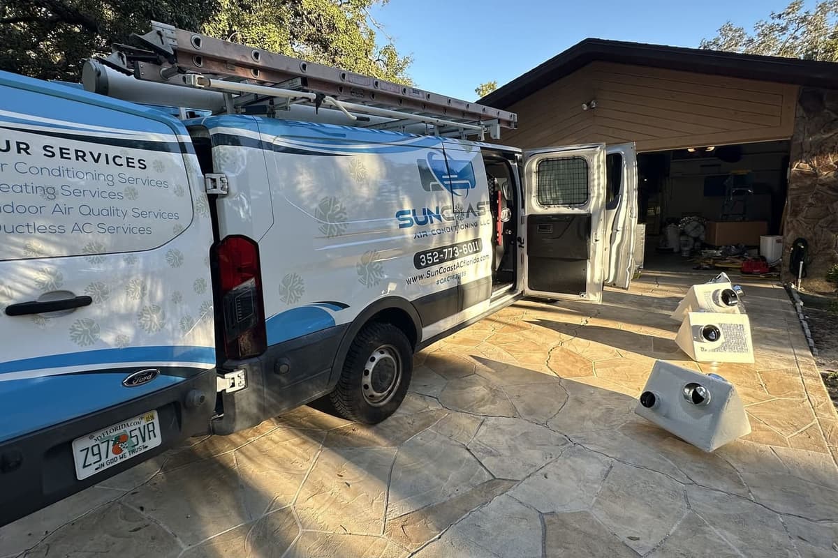 The SunCoast van with its side door open outside a garage in Hernando County, FL.