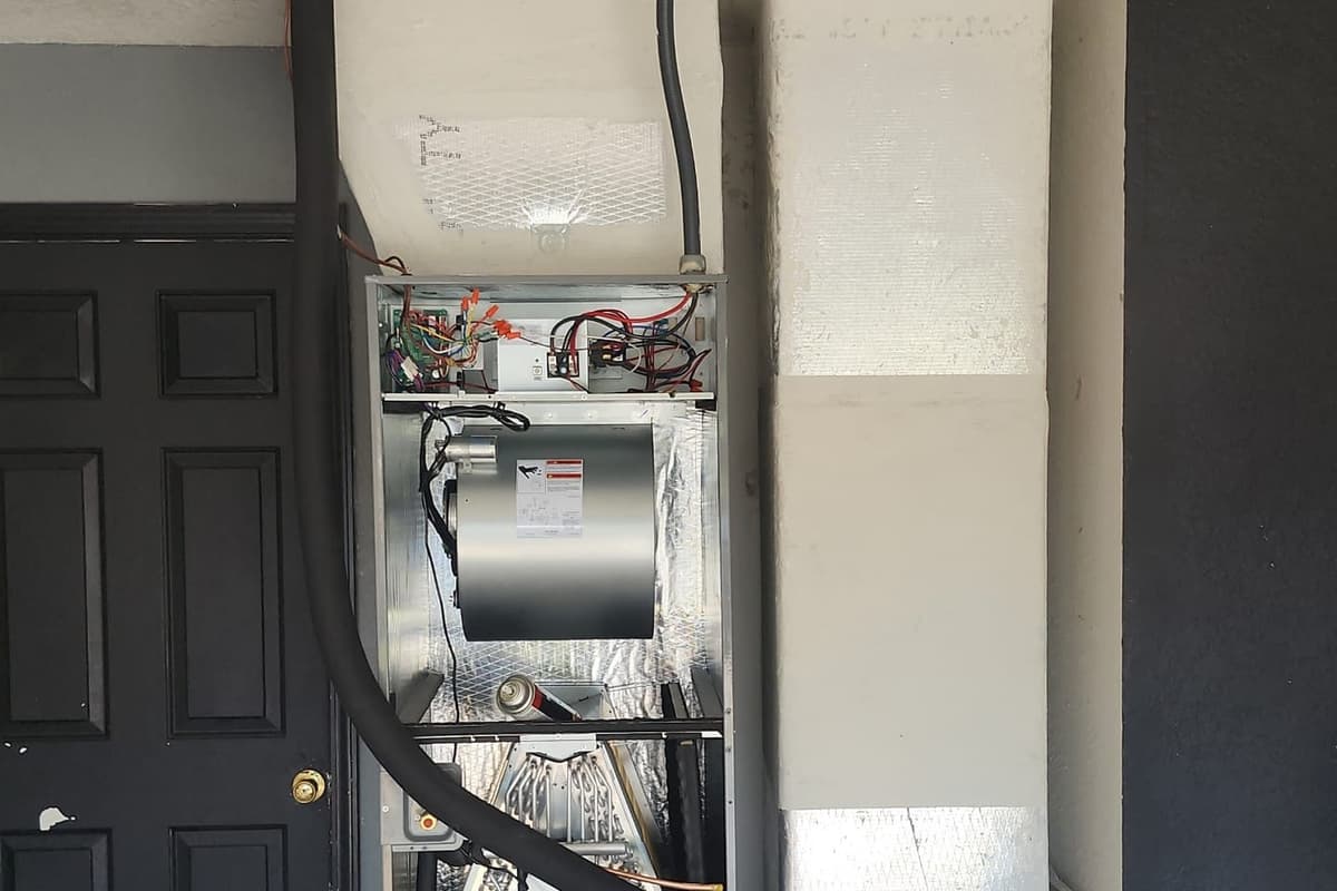 An air handler cabinet with its access panel open.