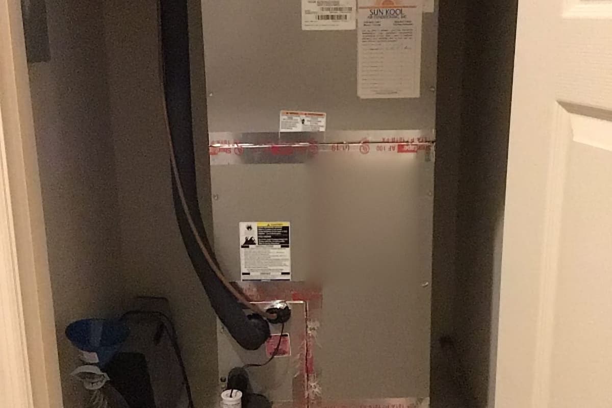 An air handler with a freshly sealed duct connection.
