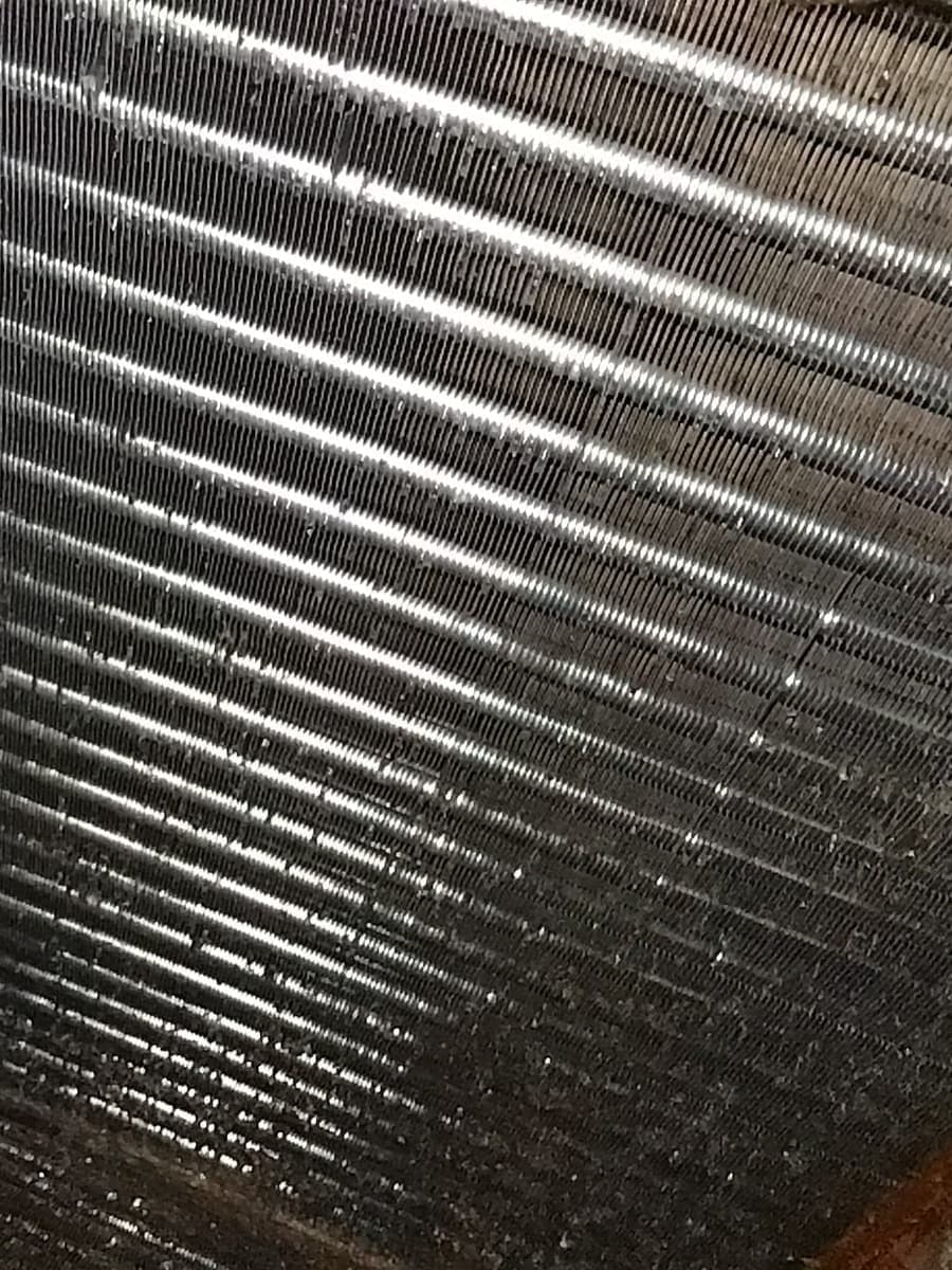 An evaporator coil with its fins clogged.