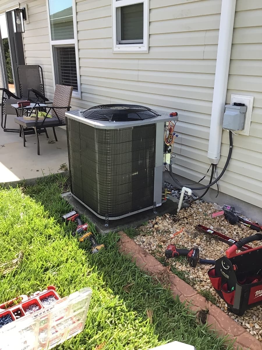 An outdoor condenser beside a patio on a Florida home.