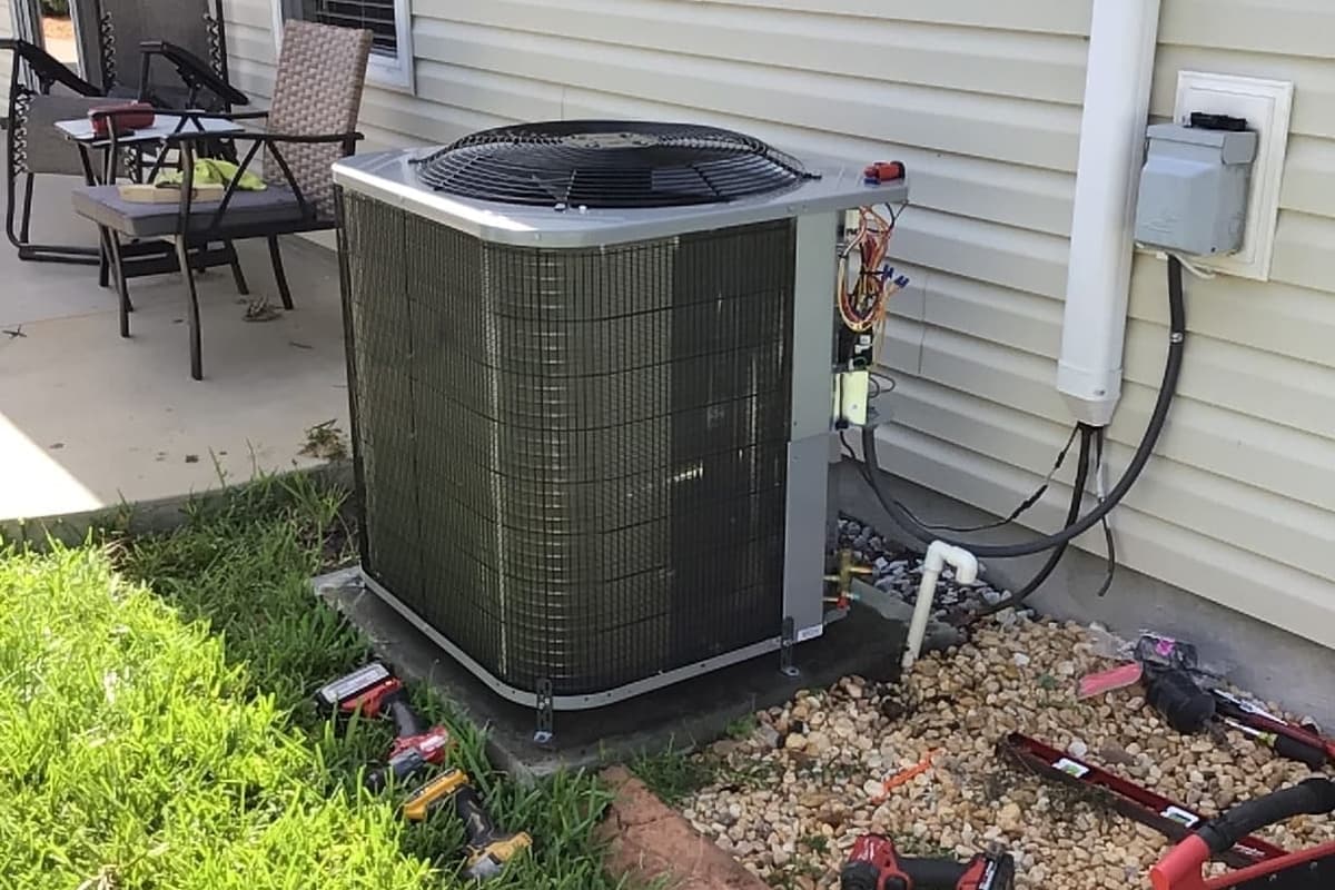 An outdoor condenser beside a patio on a Florida home.
