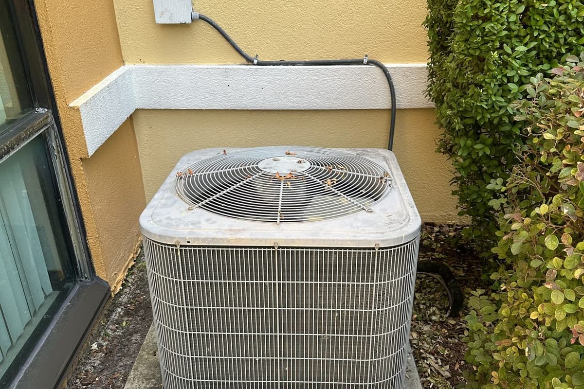 An outdoor condenser under a window on a concrete pad in Hernando County, FL.