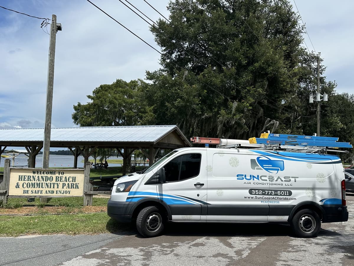 SunCoast Air Conditioning van parked next to the Hernando Beach and Community Park welcome sign