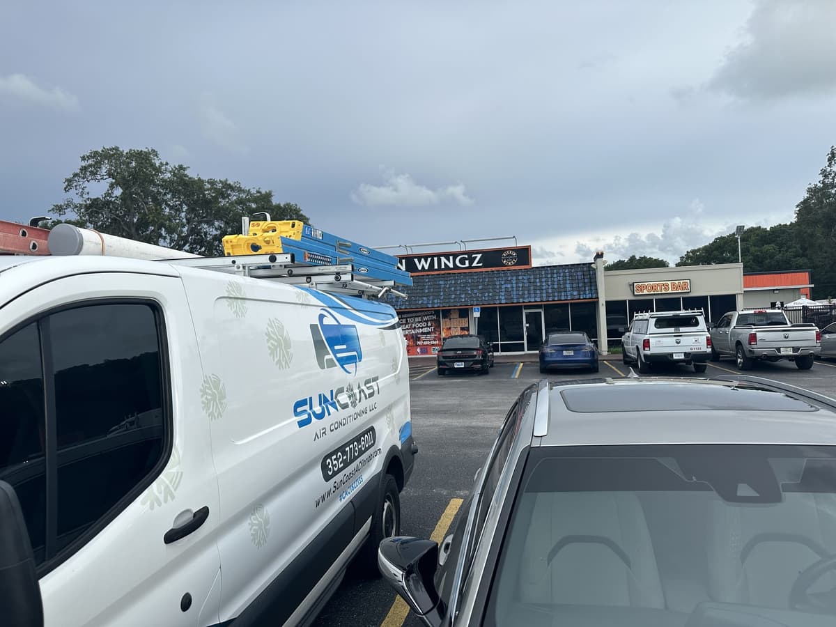 SunCoast Air Conditioning van parked in a Central Florida strip mall parking lot