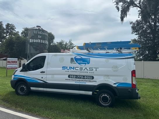 SunCoast Air Conditioning van beside the Welcome to Brooksville sign