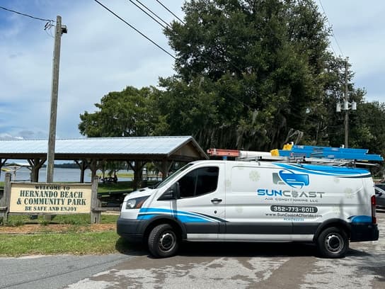 SunCoast Air Conditioning van beside the Welcome to Hernando Beach & Community Park sign in Hernando, Florida