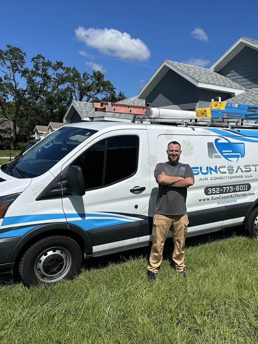 A SunCoast technician standing beside the branded service van in Spring Hill, FL.