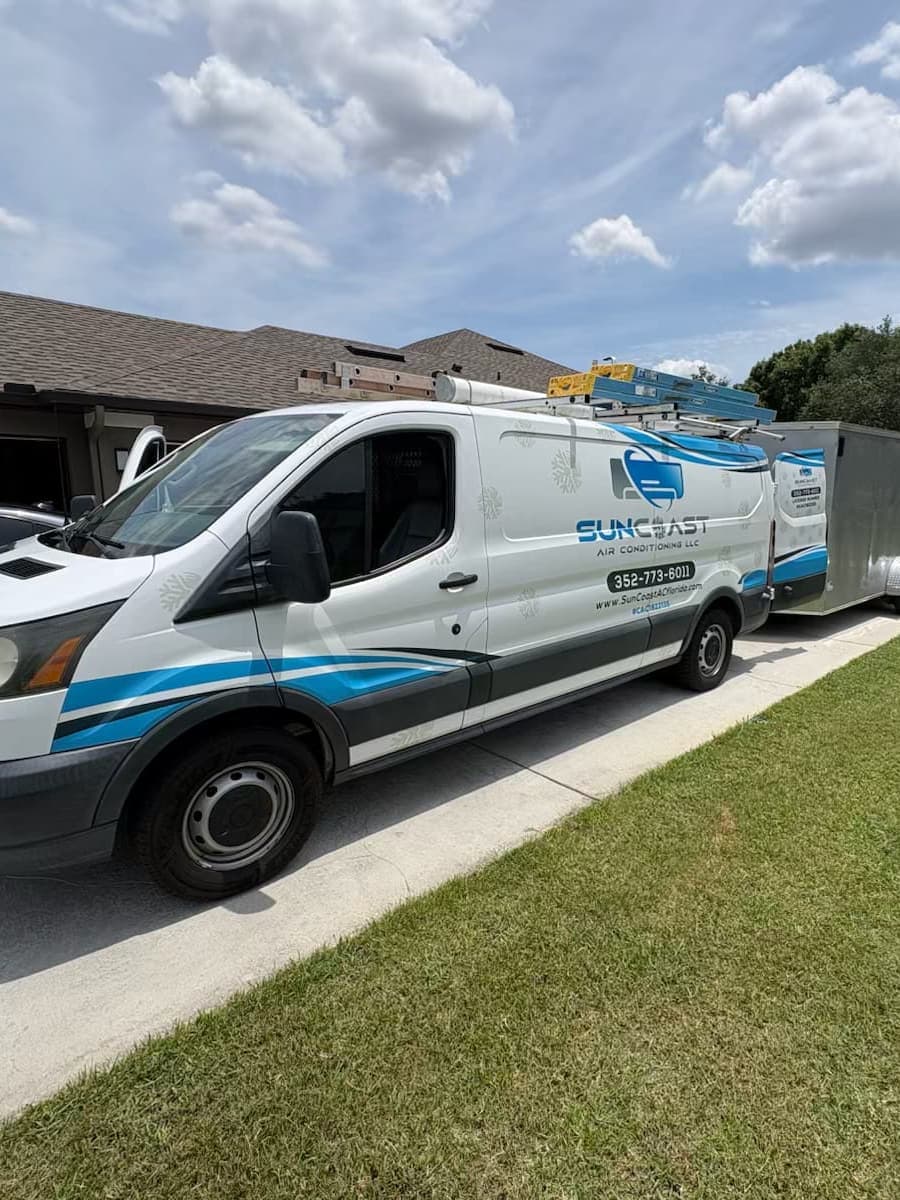 The SunCoast van parked in a driveway beside a lawn.