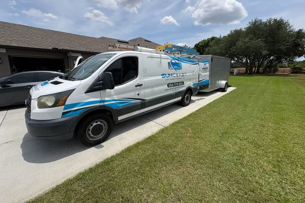 The SunCoast van parked in a driveway beside a lawn.