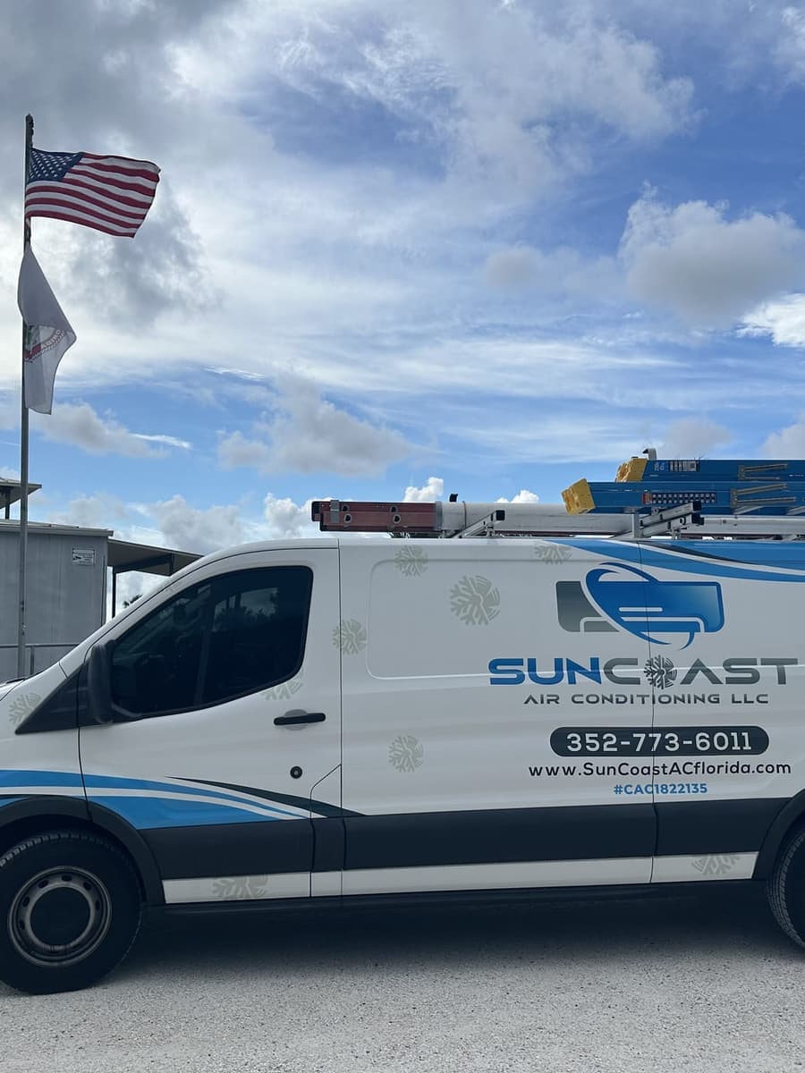 The SunCoast van parked beside a flag pole in Port Richey, FL.