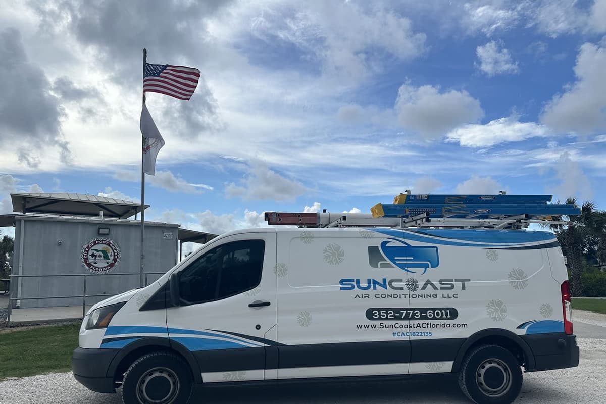 The SunCoast van parked beside a flag pole in Port Richey, FL.