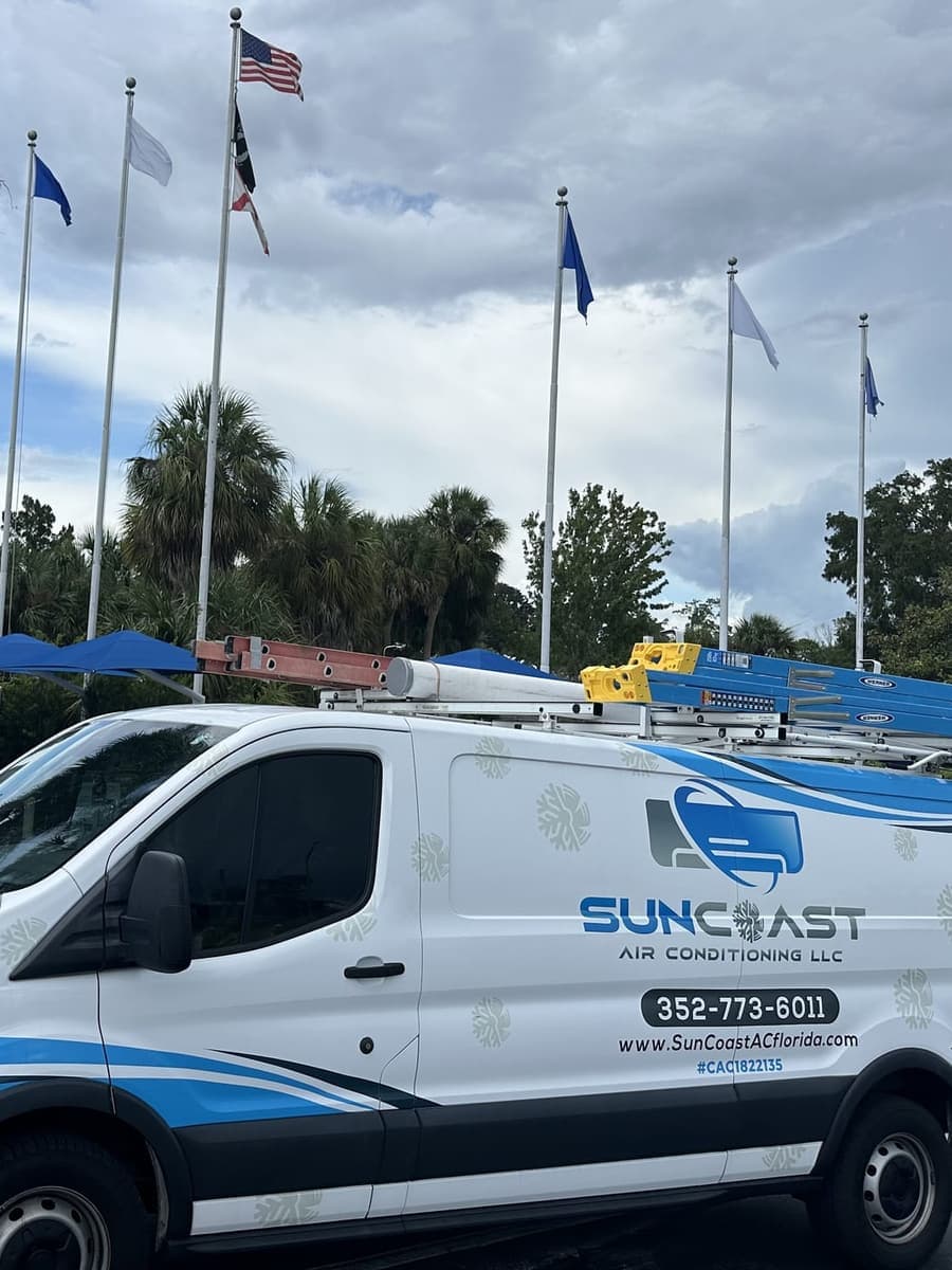 The SunCoast van parked under a row of flags in Weeki Wachee, FL.