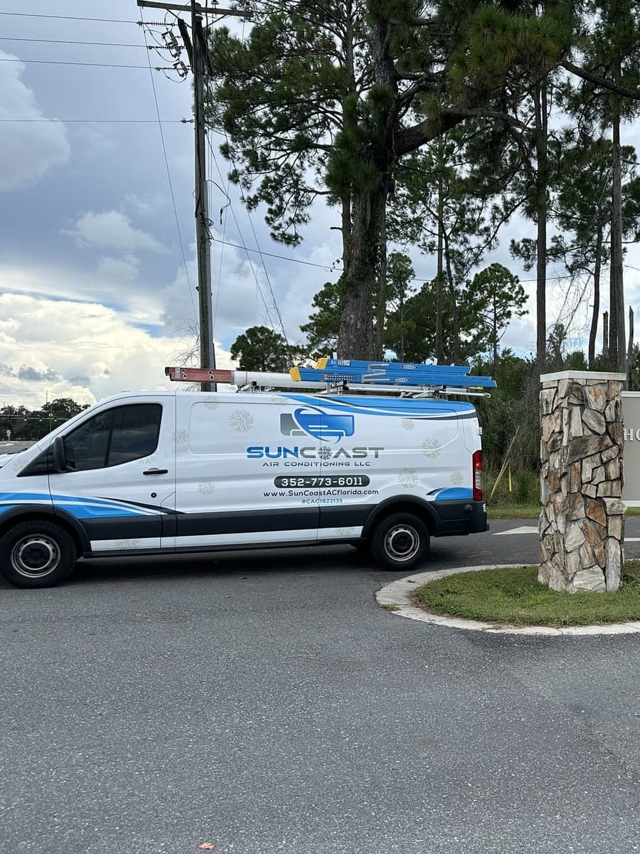The SunCoast van parked beside a stone entrance sign in Homosassa, FL.