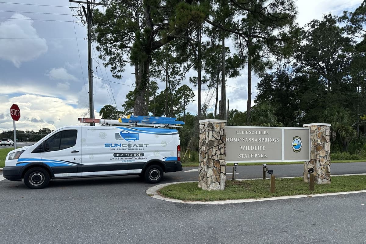 The SunCoast van parked beside a stone entrance sign in Homosassa, FL.