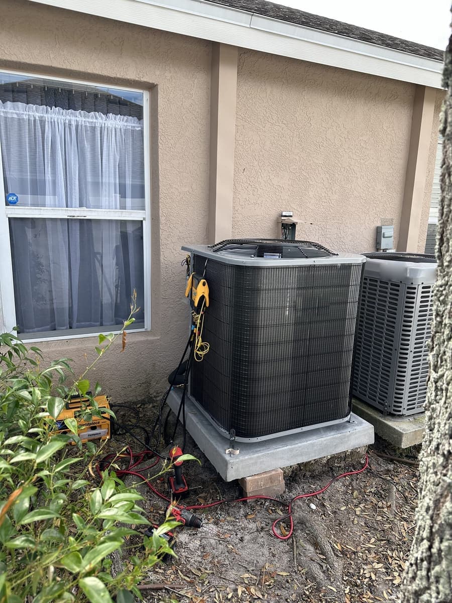 Two outdoor condensers side by side with gauges connected in Pasco County, FL.
