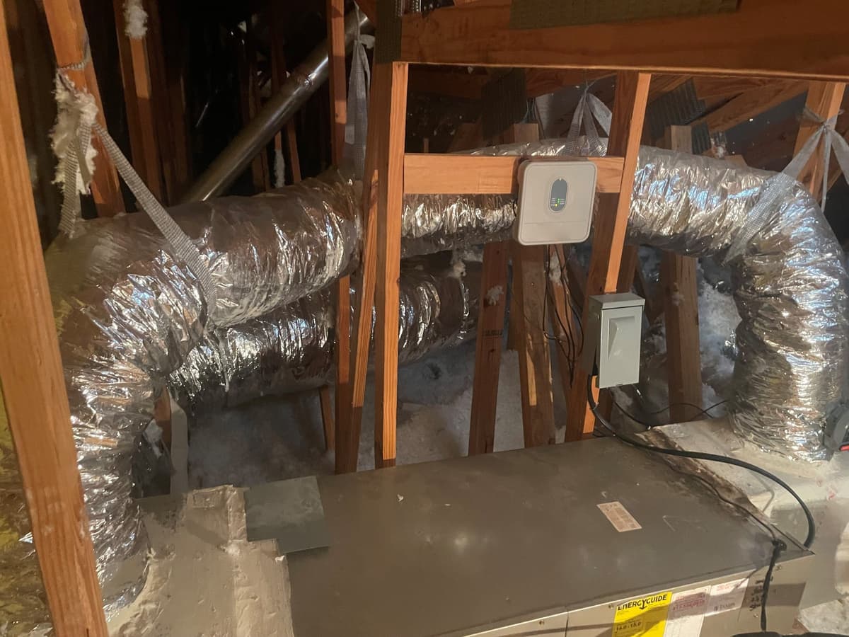 Insulated flexible ductwork and air handler in a Wesley Chapel attic during an AC repair