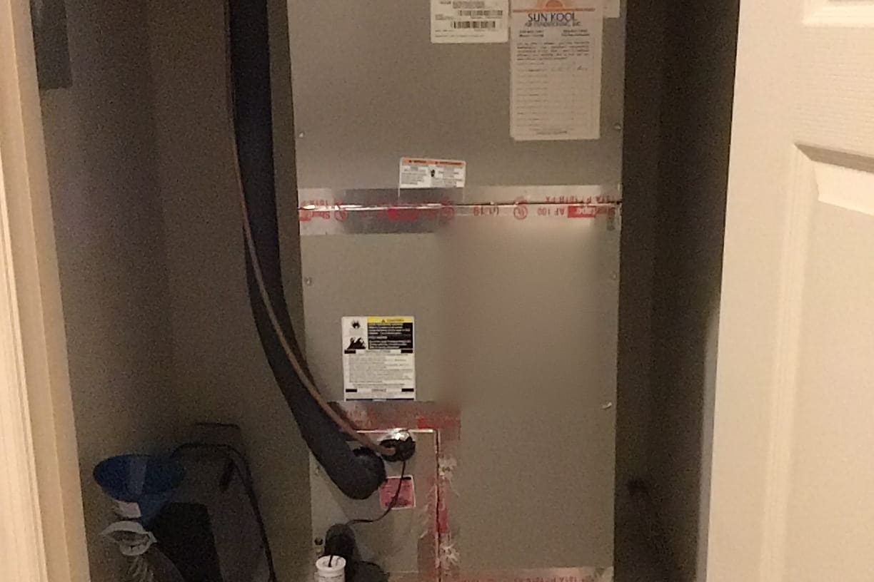 An air handler with a freshly sealed duct connection.