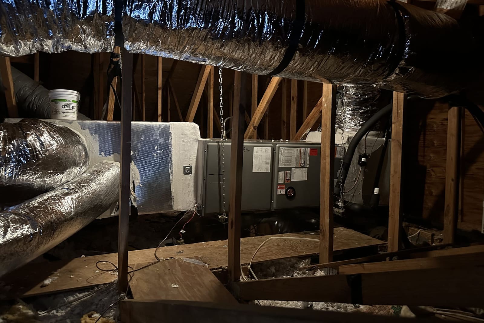 Attic ductwork and an air handler in the rafters in Spring Hill, FL.