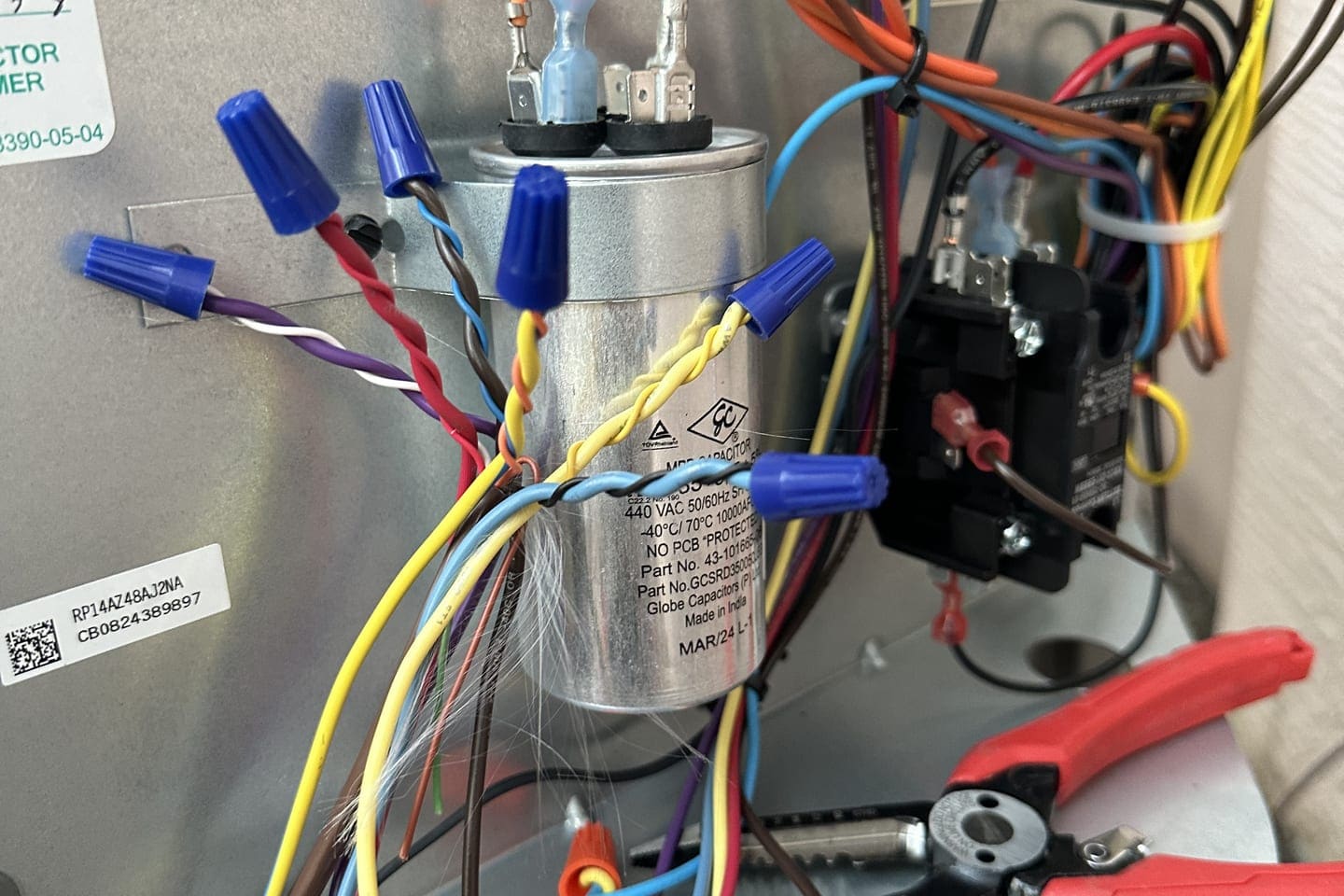 A capacitor and contactor wiring in an outdoor condenser panel in Spring Hill, FL.