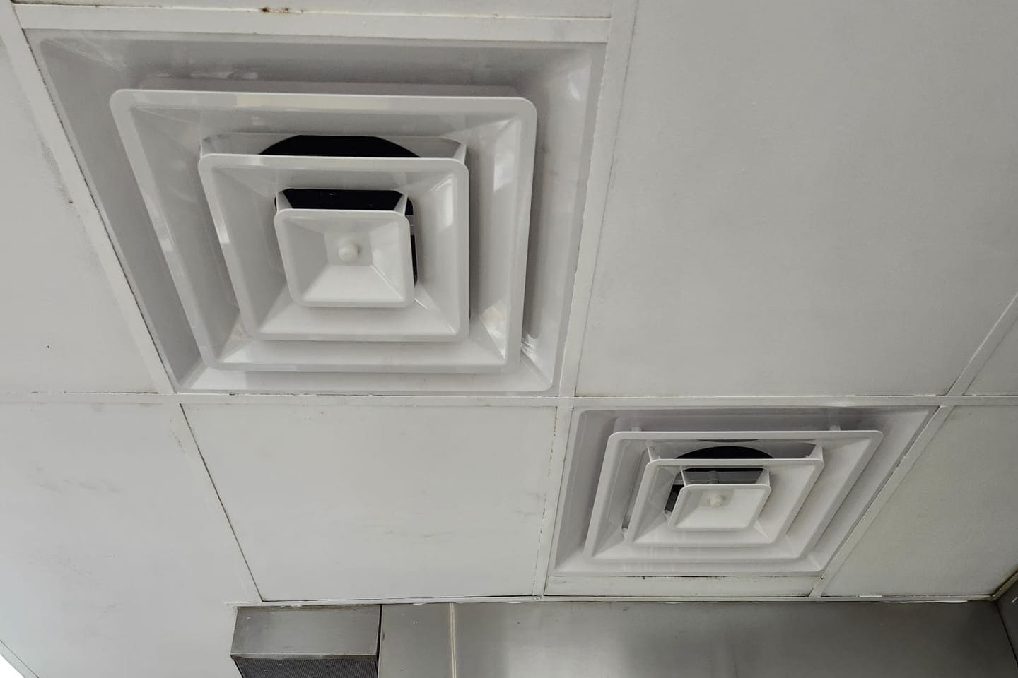 A dusty ceiling supply diffuser.